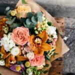 Colorful,Bouquet,Of,Different,Fresh,Flowers,Against,Brick,Wall.,Bunch